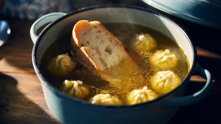Illustration of a slice of bread dissolving into a simmering soup to thicken it, with small dumplings formed from the soaked bread poaching in the broth