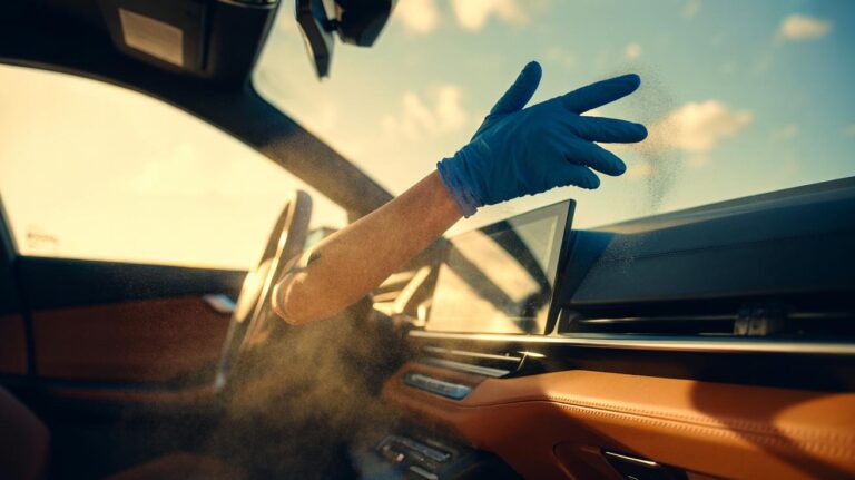 Illustration of a rubber-gloved hand using static to lift dust from a car dashboard in one wipe