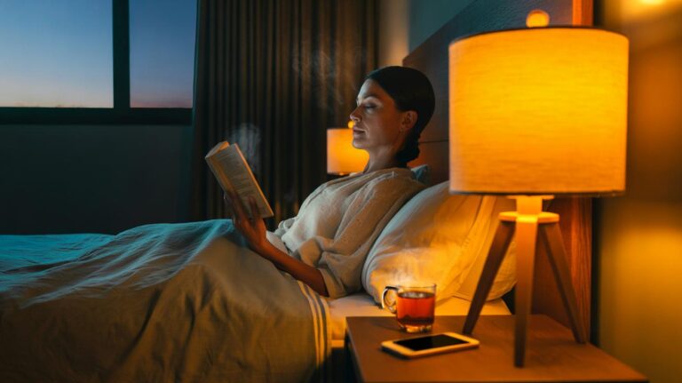 Illustration of an evening wind-down ritual with dim, warm lighting that cues natural melatonin production before sleep